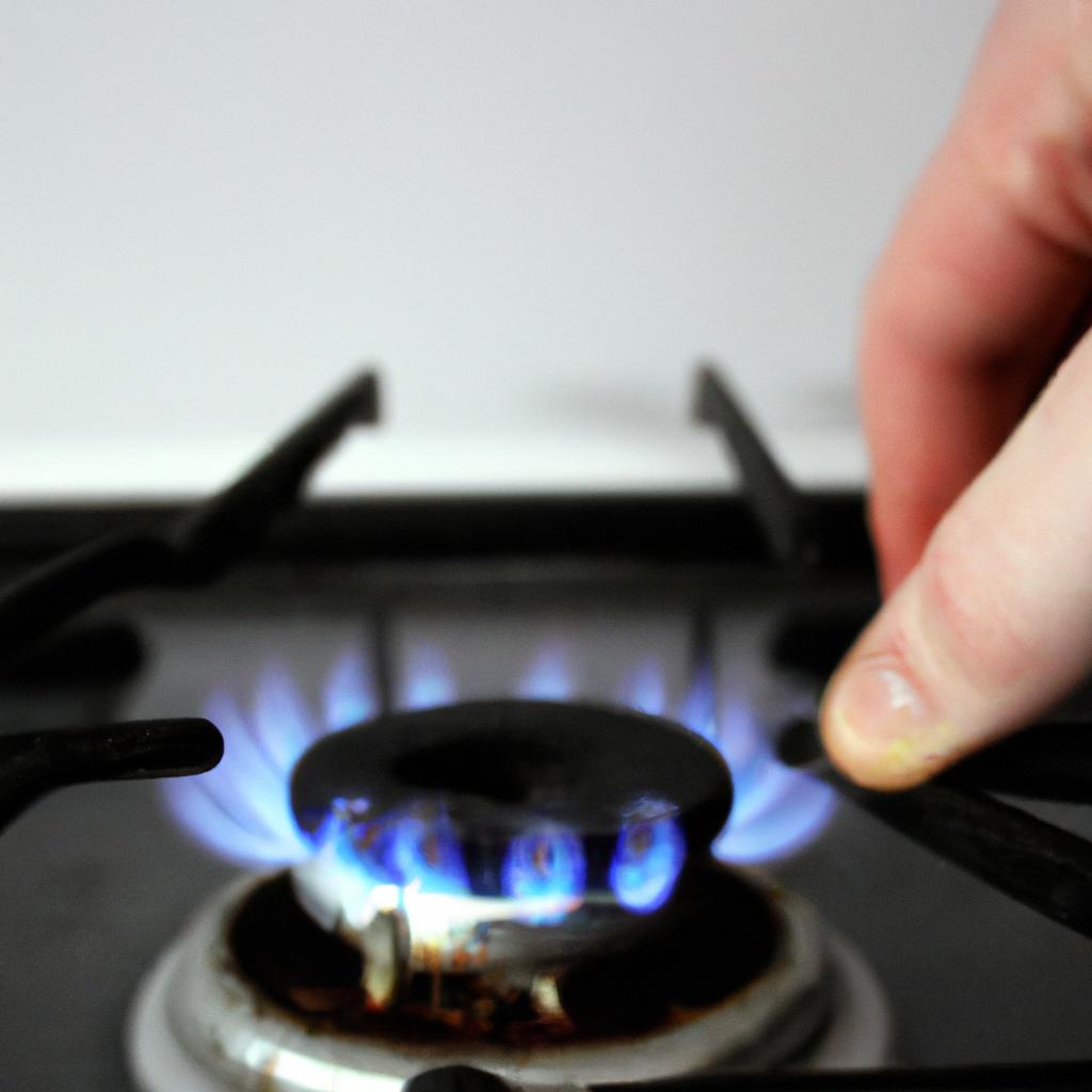 Person adjusting gas appliance flame
